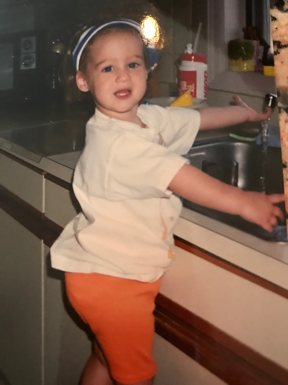 Childhood photo at the kitchen sink